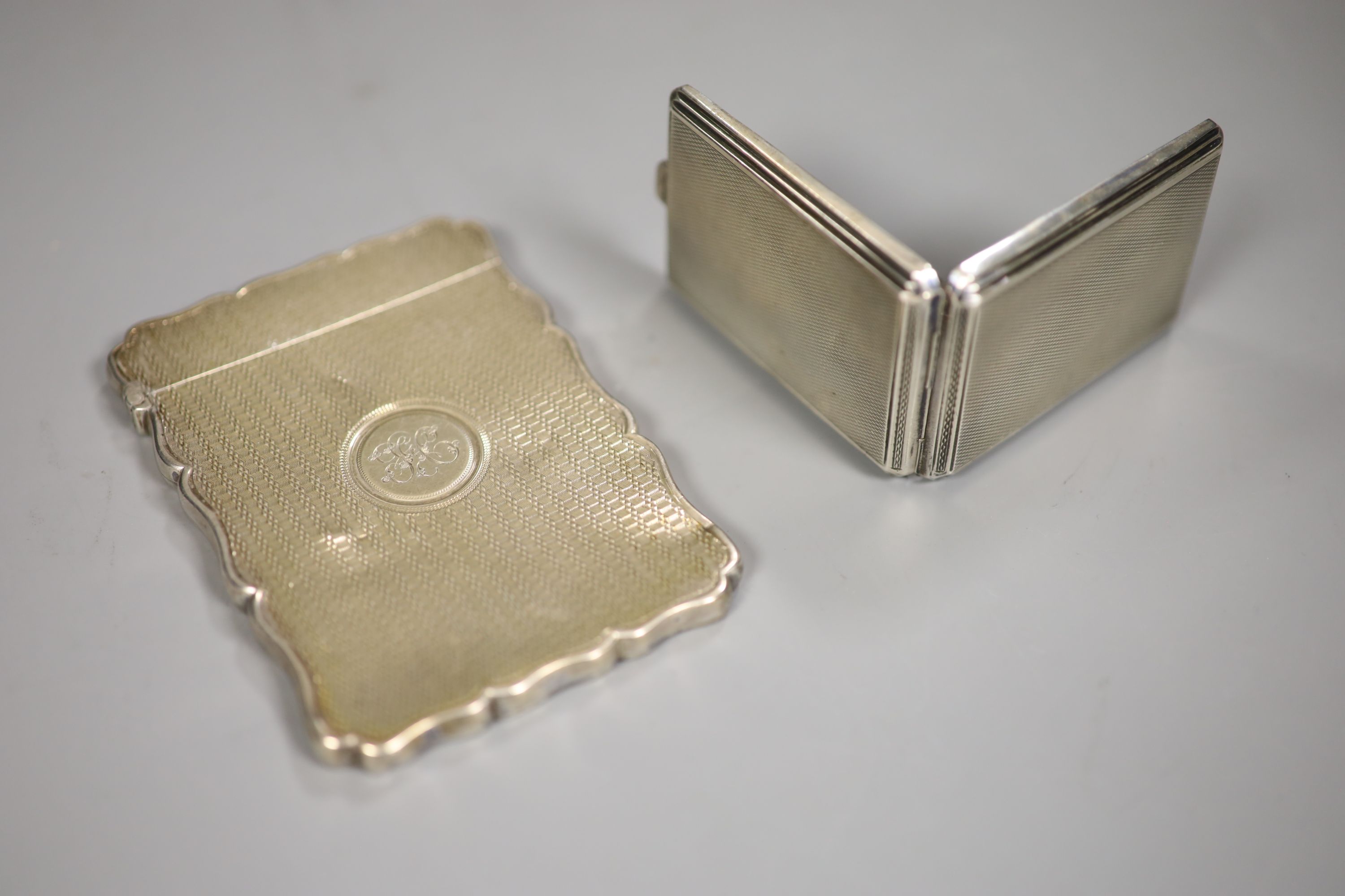 A Victorian engine turned silver card case, Birmingham, 1866 and a George V silver small card case, 63mm.